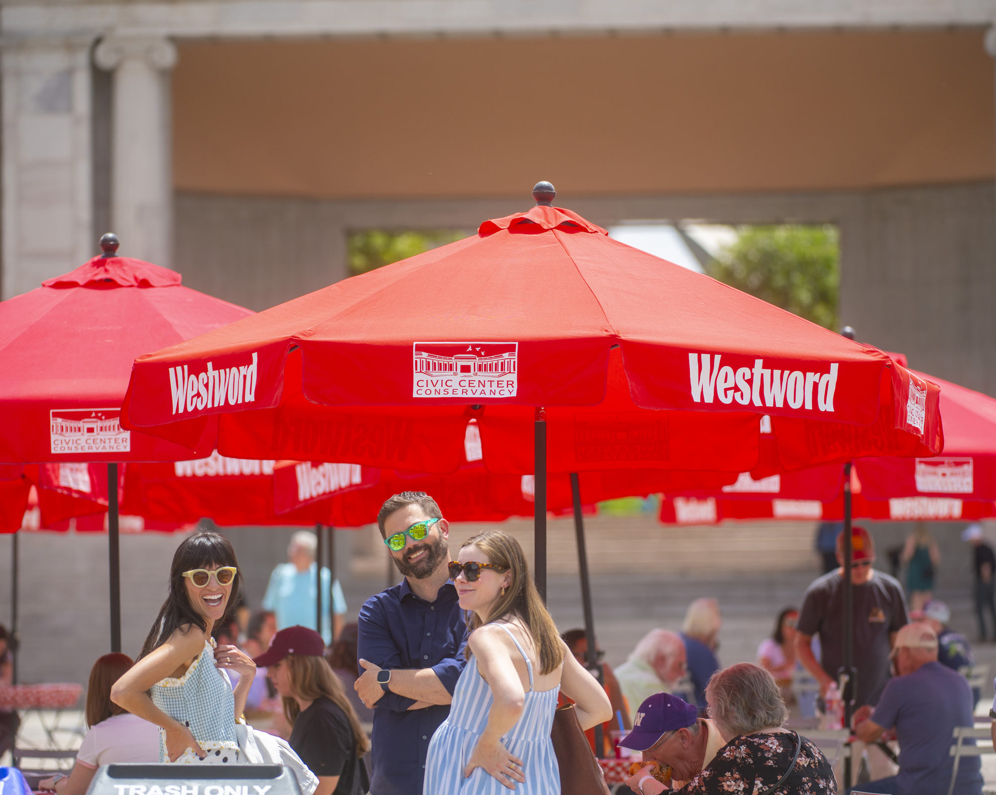 civic-center-eats-westword 3 smiling people among a crowd at Civic Center EATS