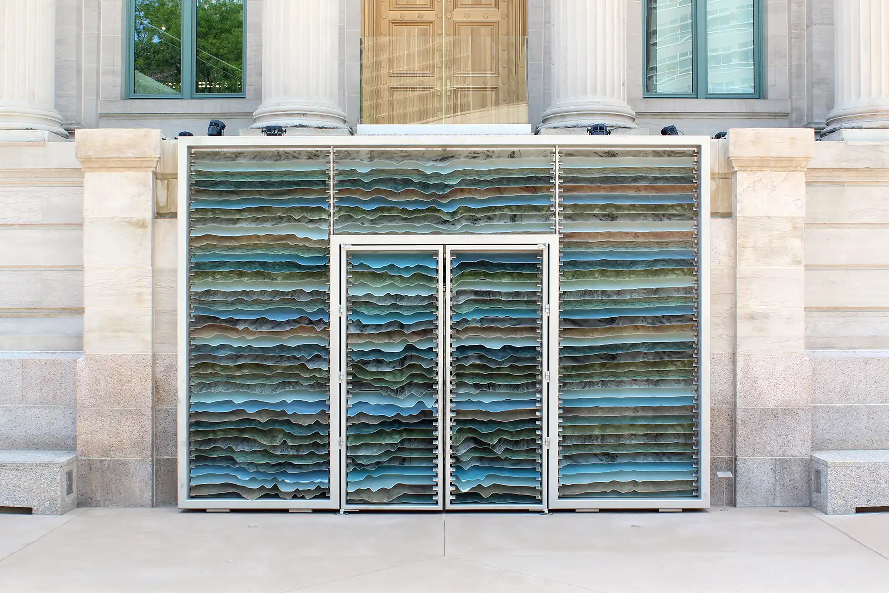 mine-craft-civic-center-park-mcnichols-doors Mine Craft artwork is wavy, multi-colored panes of glass in greens, blues, and browns installed in the doorway.